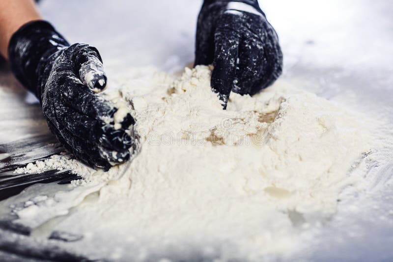 Baker`s Hands in Black Gloves Knead the Dough Stock Photo - Image of ...
