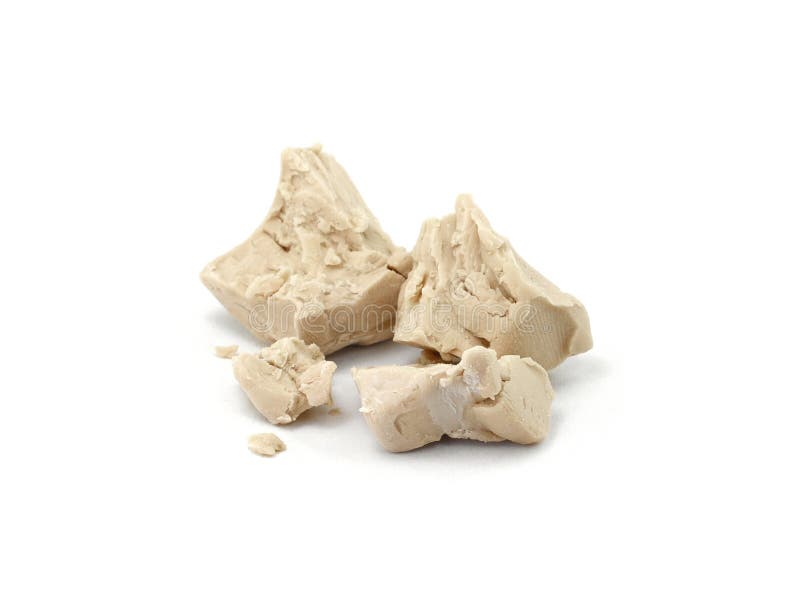 Baker`s yeast isolated on white background. A block of compressed fresh yeast isolated.