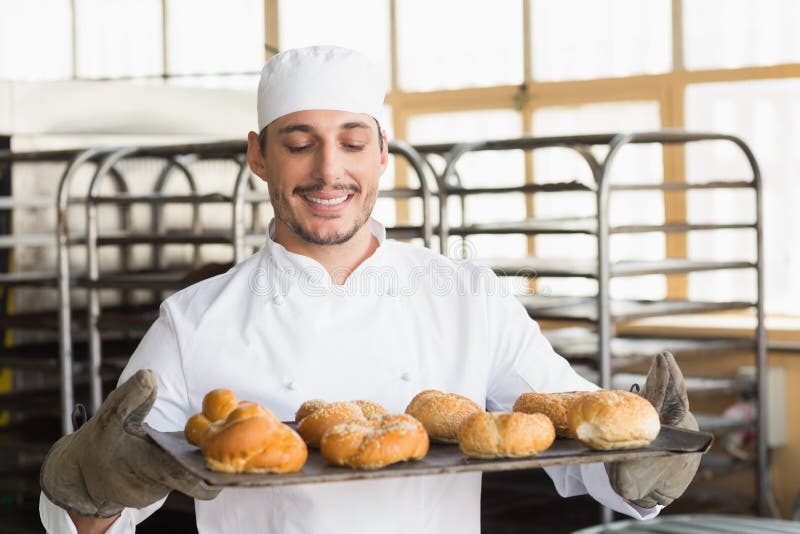 Baker Showing Tray of Rolls Stock Photo Image of person, business