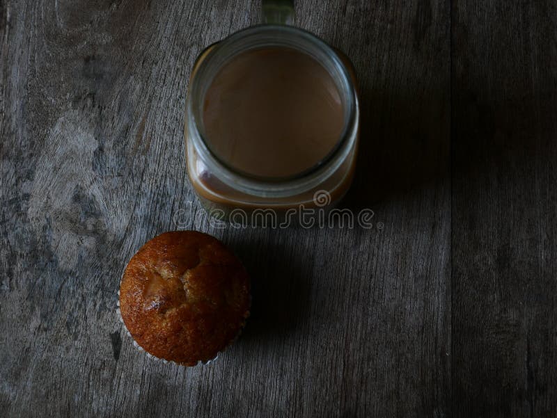 Bakery fresh banana cup cake and coco milk. Bakery fresh banana cup cake hot tea and coffee, home made food stock image Bakery fresh banana cup cake and coco milk. Bakery fresh banana cup cake hot tea and coffee, home made food stock image