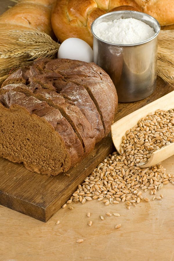 Bakery products and grain on wood