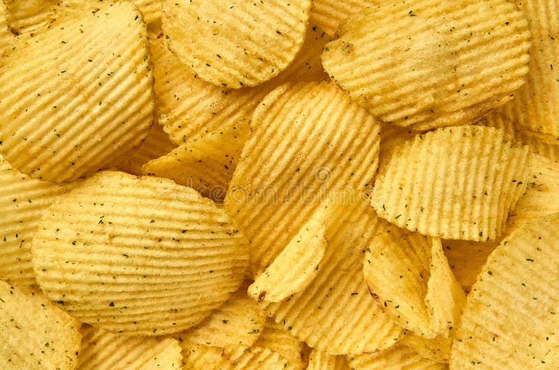 Bakgrund av den saftiga korrugerade närbilden för potatischiper arkivfoto Bakgrund av den saftiga korrugerade närbilden för potatischiper arkivfoto