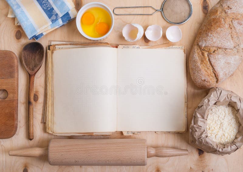 Baking light warm background with blank cook book, cutting board, eggshell, bread, flour, rolling pin. Vintage wood table from above. Rustic background with free text space. Vintage rustic recipe book background stock images, royalty-free photos and pictures