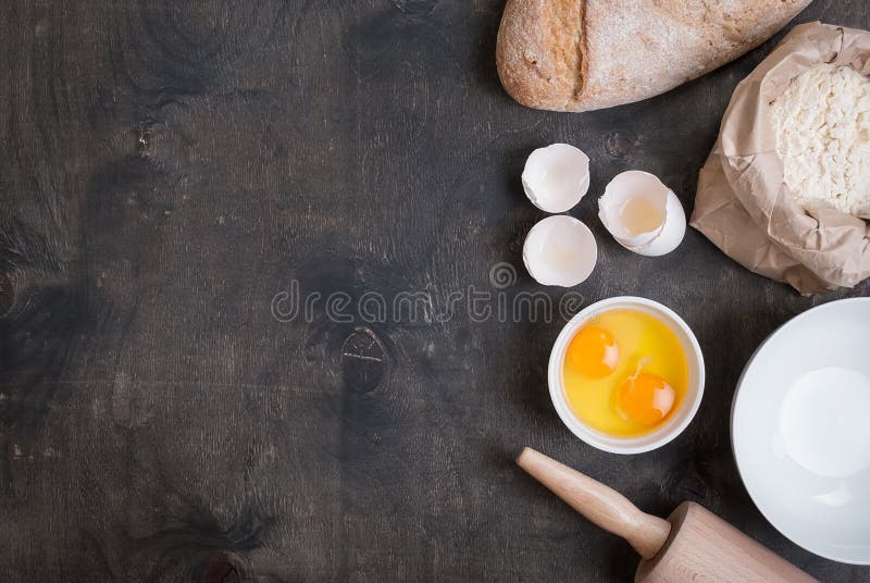 Baking dark background with blank cook book, eggshell, bread, flour, rolling pin. Vintage wood table from above. Rustic background with free text space. Vintage rustic recipe book background stock images, royalty-free photos and pictures