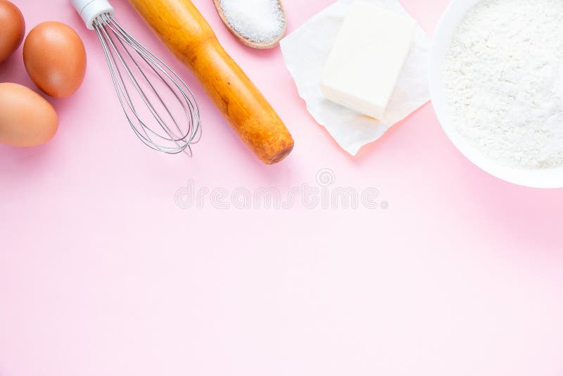 Baking Background on a Pastel Pink Background. Ingredients and Tools