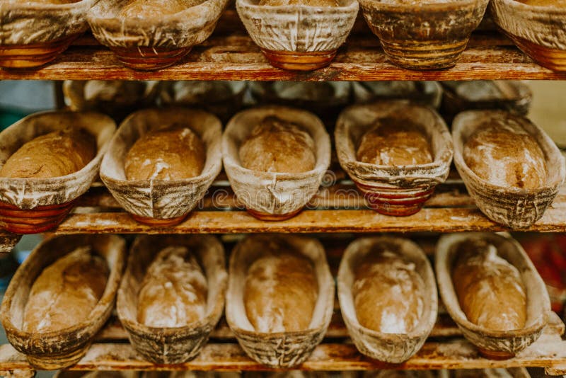 Baking Bread. Dough in Proofing Basket on Wooden Table with Flour