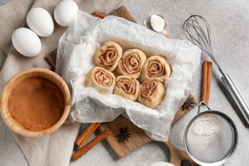 Baking Dish with Uncooked Cinnamon Rolls and Ingredients on Kitchen