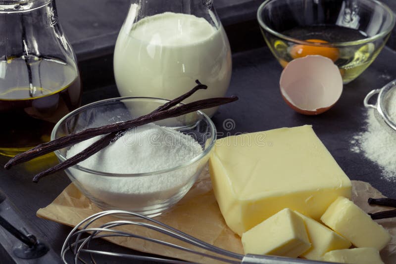 Baking ingredients eggs, flour, sugar, butter, vanilla, cream