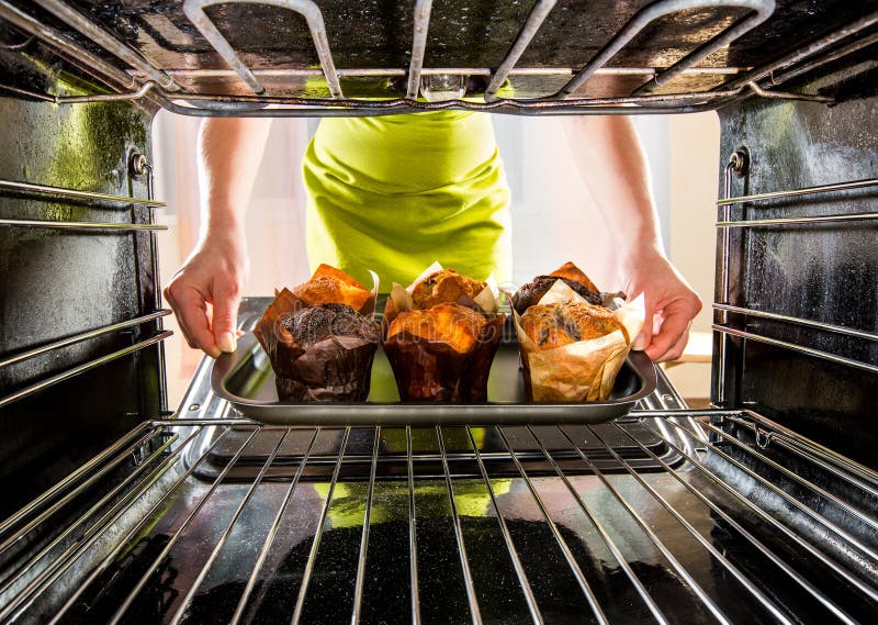 Baking muffins in the oven stock photo. Image of fudge - 57110366