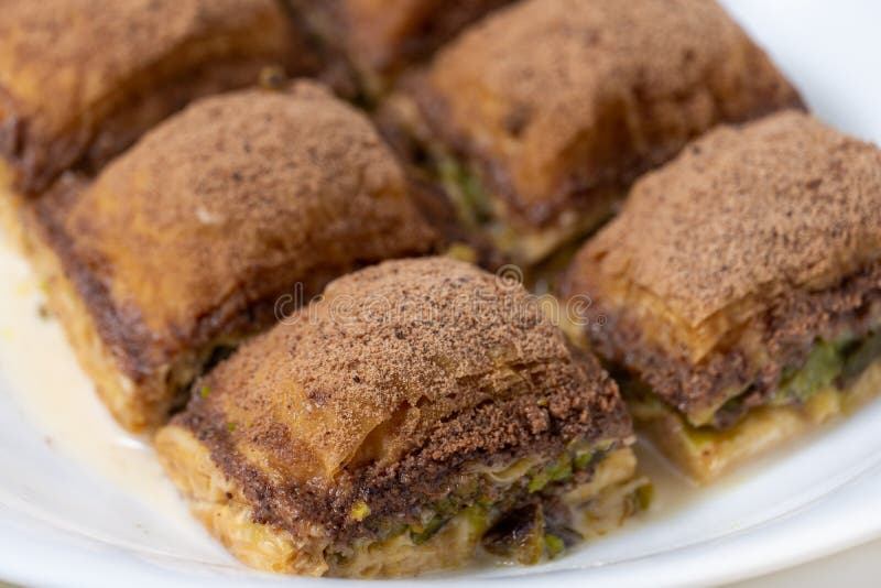 Turkish close up baklava with cocoa and milk on white plate. Turkish close up baklava with cocoa and milk on white plate.