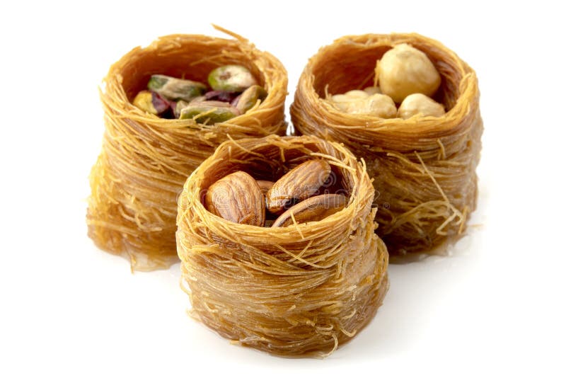 Mixed Bird nest baklava with almonds, nuts and pistachios on a white background. Mixed Bird nest baklava with almonds, nuts and pistachios on a white background