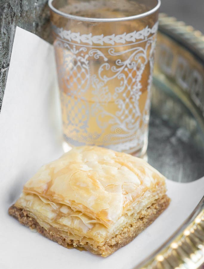 Baklava and a Glass of Tea on a silver Tablet. Baklava and a Glass of Tea on a silver Tablet
