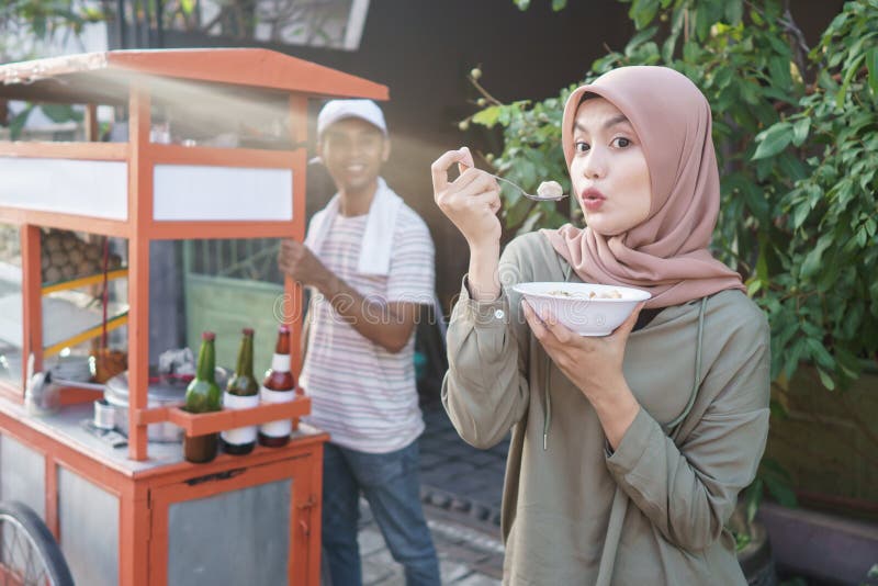 Bakso. indonesian famous meatball street food. asian woman enjoy eating bakso. Bakso. indonesian famous meatball street food. asian woman enjoy eating bakso