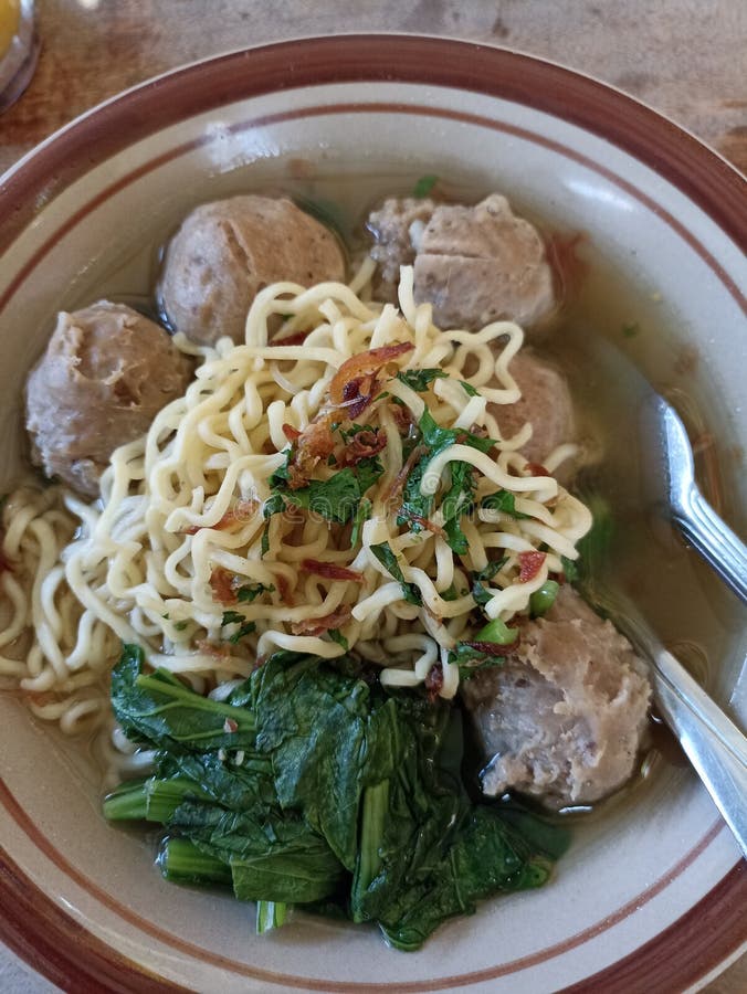 Bakso, Indonesian Famous Meatballs served with noodles in a brown bowl. Bakso, Indonesian Famous Meatballs served with noodles in a brown bowl.