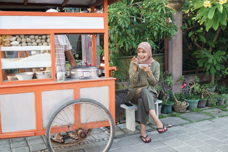 Bakso. indonesian famous meatball street food. asian women enjoy eating bakso. Bakso. indonesian famous meatball street food. asian women enjoy eating bakso