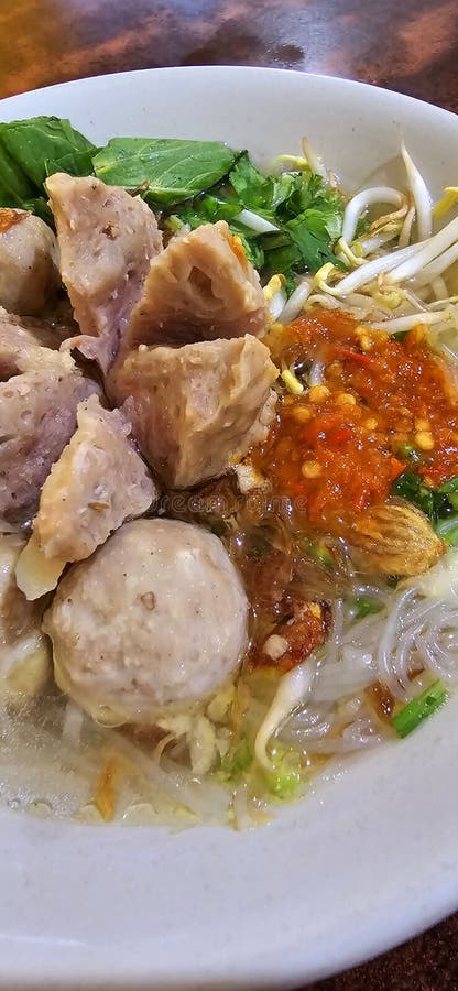 Bakso, indonesian meatball style served with beef broth soup and noodle springkled with fried onion and spring onion coupled with chili sauce on the top, very famous Asian street food