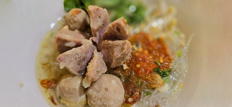 Bakso, indonesian meatball style served with beef broth soup and noodle springkled with fried onion and spring onion coupled with chili sauce on the top, very famous Asian street food