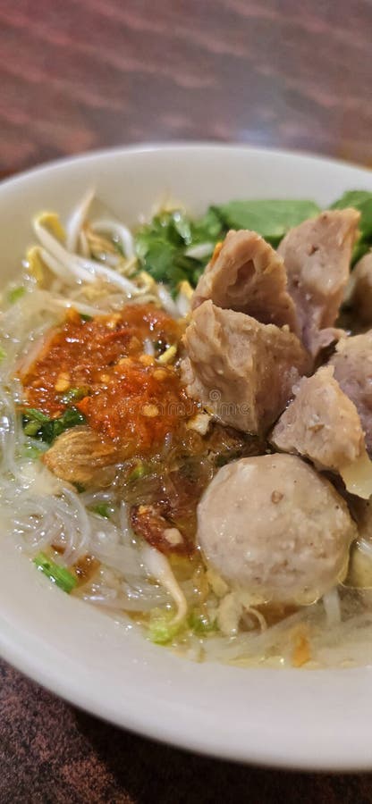 Bakso, indonesian meatball style served with beef broth soup and noodle springkled with fried onion and spring onion coupled with chili sauce on the top, very famous Asian street food