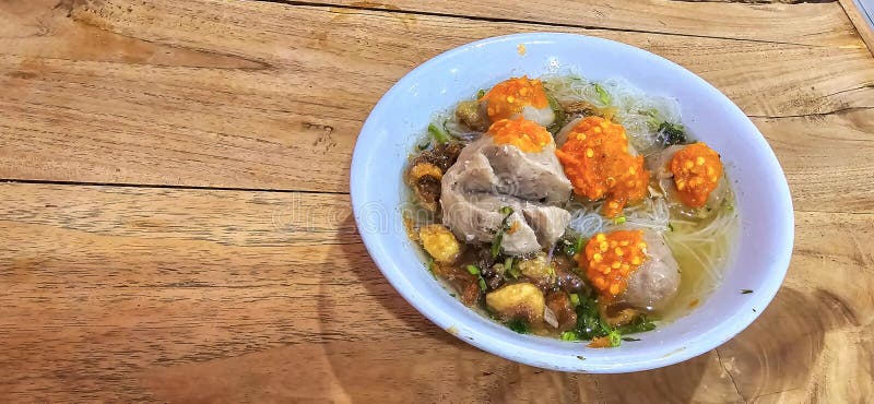 Bakso, indonesian meatball style served with beef broth soup and noodle springkled with fried onion and spring onion coupled with chili sauce on the top, very famous Asian street food