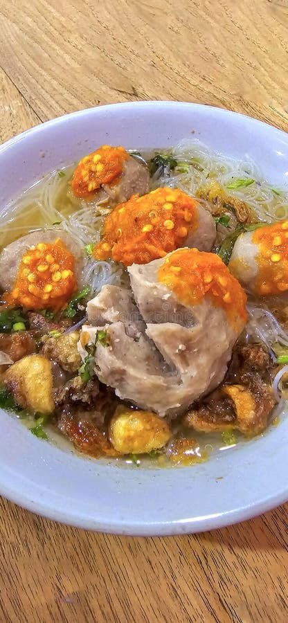 Bakso, indonesian meatball style served with beef broth soup and noodle springkled with fried onion and spring onion coupled with chili sauce on the top, very famous Asian street food