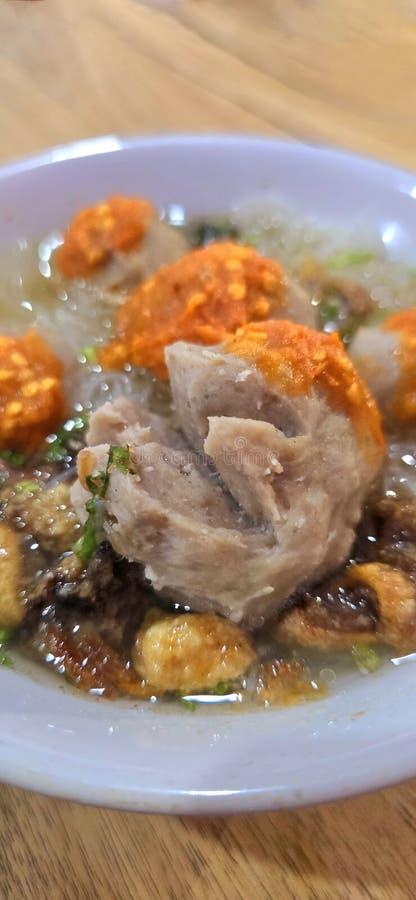 Bakso, indonesian meatball style served with beef broth soup and noodle springkled with fried onion and spring onion coupled with chili sauce on the top, very famous Asian street food