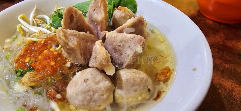 Bakso, indonesian meatball style served with beef broth soup and noodle springkled with fried onion and spring onion coupled with chili sauce on the top, very famous Asian street food. Bakso, indonesian meatball style served with beef broth soup and noodle springkled with fried onion and spring onion coupled with chili sauce on the top, very famous Asian street food