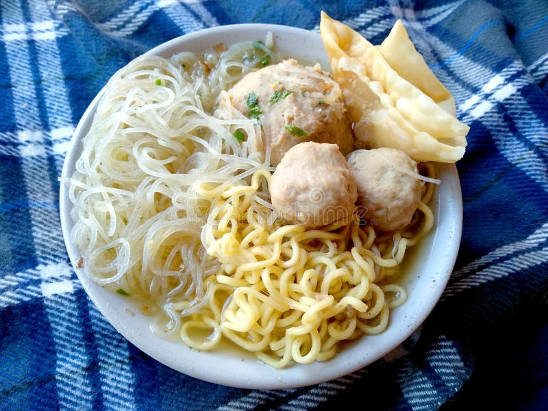 Bakso Urat Indonesian Street Food, Meatballs served with noodles and fried dumplings on the bowl