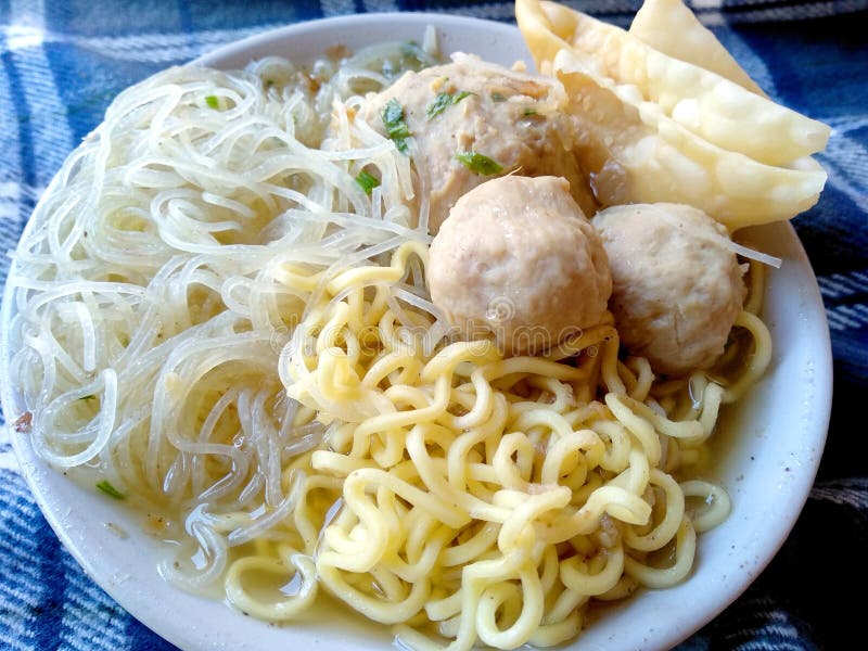 Bakso Urat Indonesian Street Food, Meatballs served with noodles and fried dumplings on the bowl