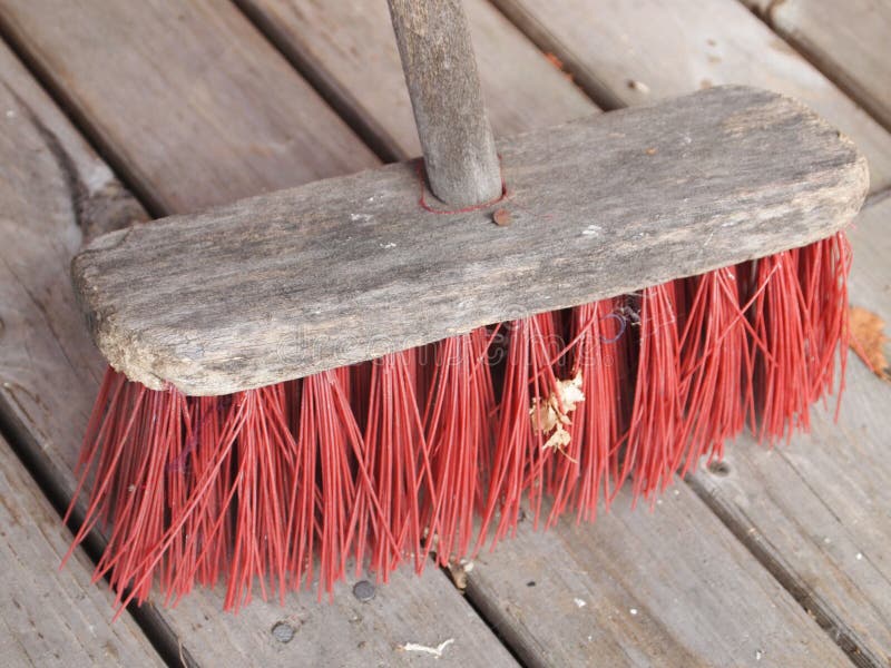 A red Broom on a wooden floor. A red Broom on a wooden floor