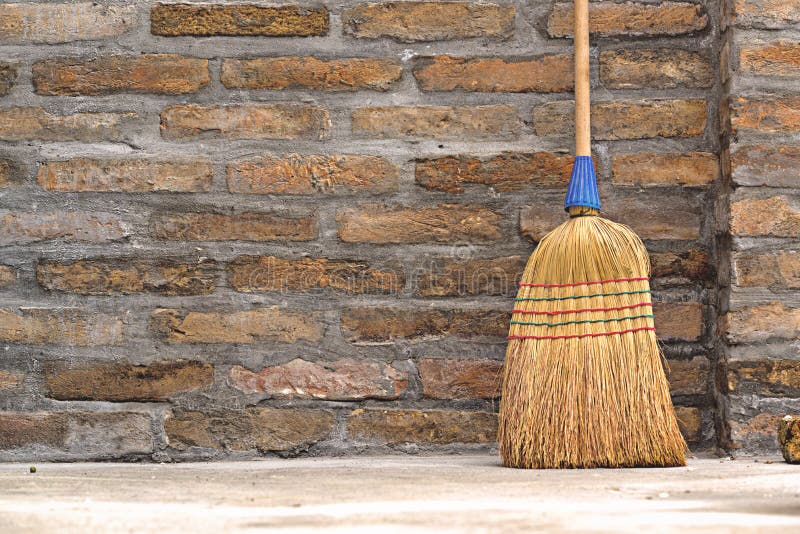Household Used Broom For Floor Dust Cleaning Leaning on Brick Wall, Horizontal. Household Used Broom For Floor Dust Cleaning Leaning on Brick Wall, Horizontal