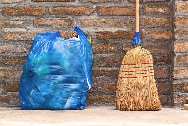 Household Used Broom For Floor Dust Cleaning and Blue Plastic Garbage Bag, Horizontal. Household Used Broom For Floor Dust Cleaning and Blue Plastic Garbage Bag, Horizontal