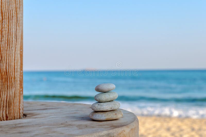 Balanced several Zen stones on blurred beautiful the beach. Balanced several Zen stones on blurred beautiful the beach