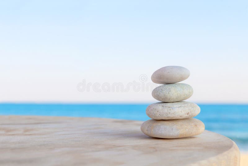 Balanced several Zen stones on blurred beautiful beach. Balanced several Zen stones on blurred beautiful beach