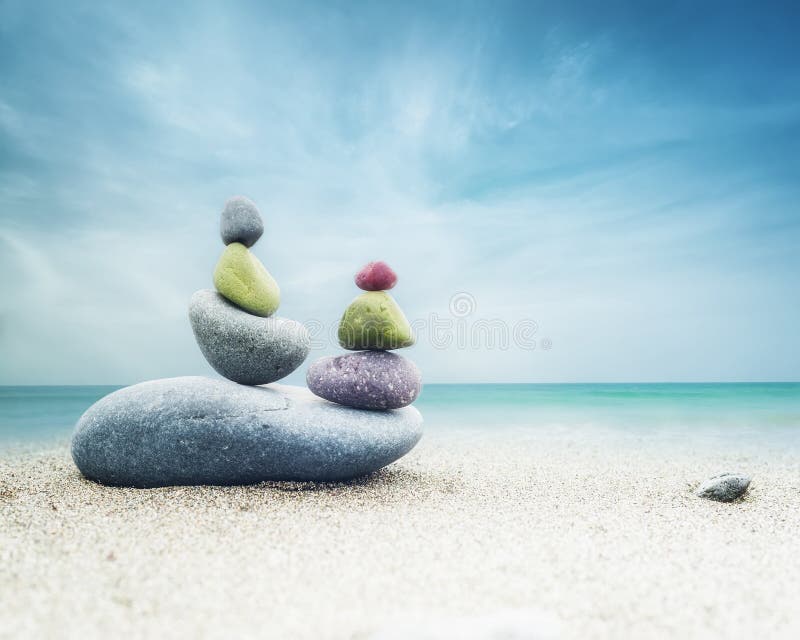 Balancing zen stones pyramid on sand