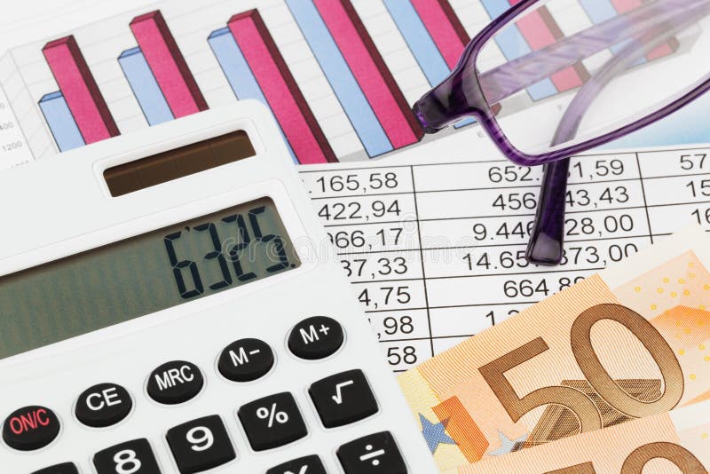 A calculator with graphics of a balance sheet. Sales, profit and operational costs. A calculator with graphics of a balance sheet. Sales, profit and operational costs.