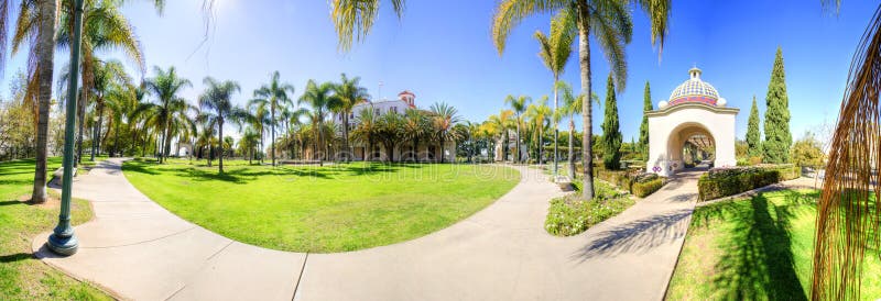 A panoramic view of the Veterans Museum and Memorial Center as well as some of the arched colorful mosaic architecture and palm trees in the Balboa Park in San Diego, California in the United States of America. A panoramic view of the Veterans Museum and Memorial Center as well as some of the arched colorful mosaic architecture and palm trees in the Balboa Park in San Diego, California in the United States of America.