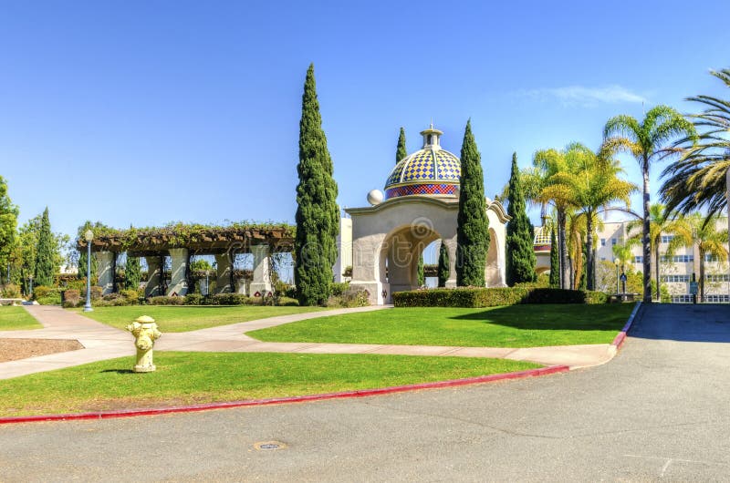 A view of the arched colorful mosaic architecture and palm trees in the Balboa Park in San Diego, California in the United States of America. A beautiful park filled with recreational activities. A view of the arched colorful mosaic architecture and palm trees in the Balboa Park in San Diego, California in the United States of America. A beautiful park filled with recreational activities.