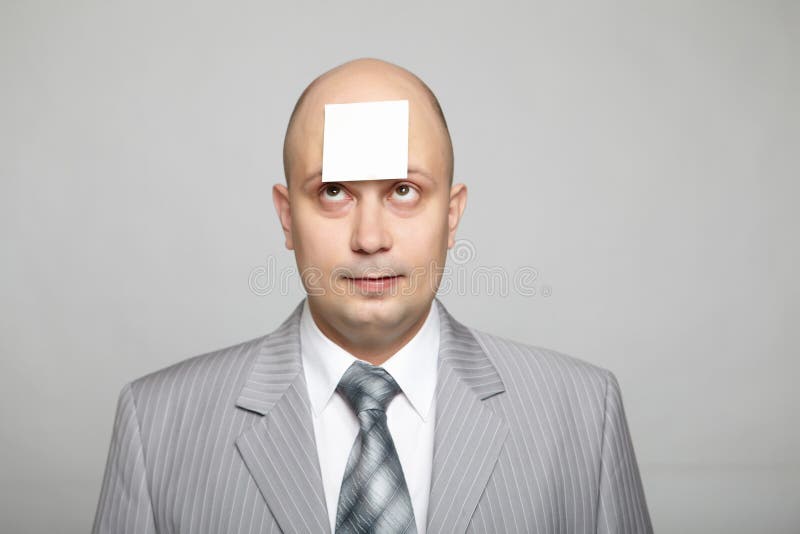 Bald businessman in a gray suit