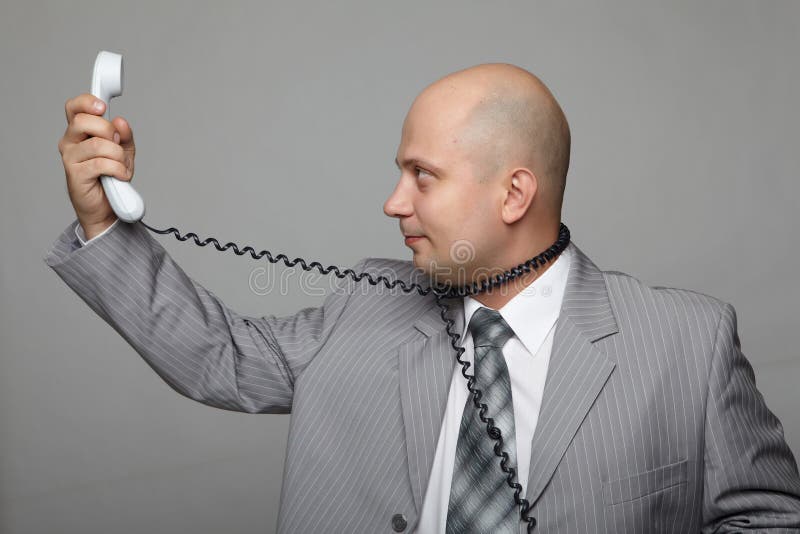 Bald businessman with the handset