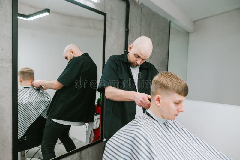 Bald Professional Barber Cuts a Young Man with a Clipper in His Hands. Barber Creates a Stylish Hairstyle for a Young Man with Stock Image - Image of haircut, male: 185496221 Bald Professional Barber Cuts a Young Man with a Clipper in His Hands. Barber Creates a Stylish Hairstyle for a Young Man with Stock Image - Image of haircut, male: 185496221