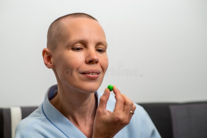 A Bald Woman Holds A Small Candy In Her Hands Sweet Temptation Stock