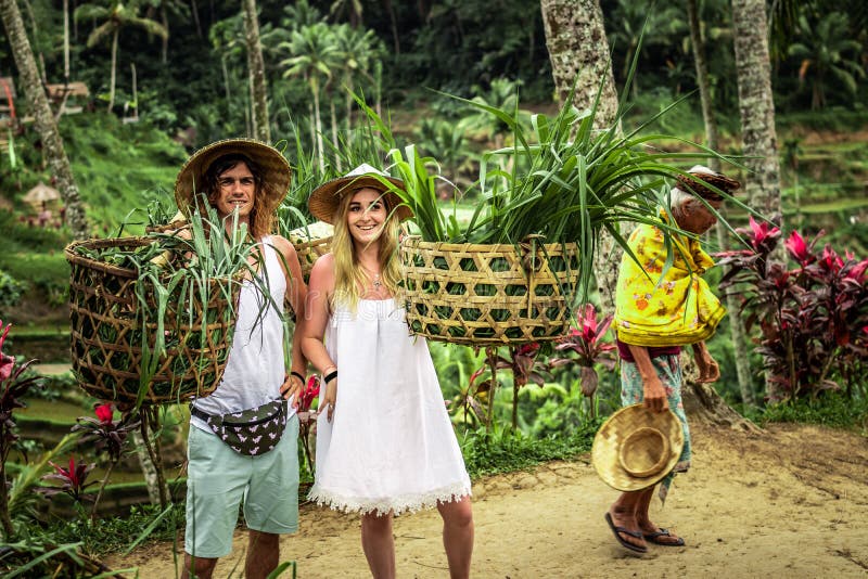 BALI, INDONESIA - AUGUST 24, 2018: Young honeymoon couple on rice fields of Bali island. Travel vacation on Bali concept