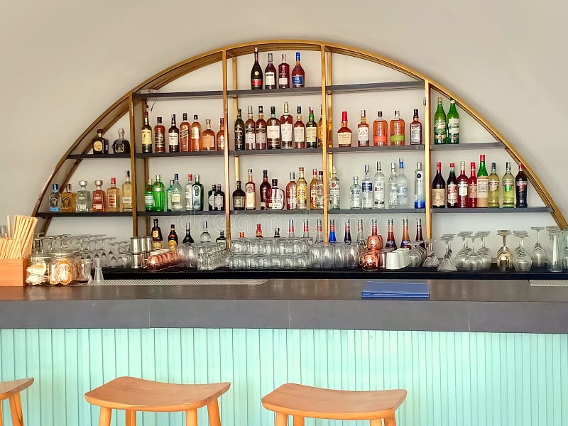 Bali, Indonesia - 15th October 2019; Rows of beverages are displayed on the bar racks in the cafe Del Mar beach club without people. Bali, Indonesia - 15th October 2019; Rows of beverages are displayed on the bar racks in the cafe Del Mar beach club without people