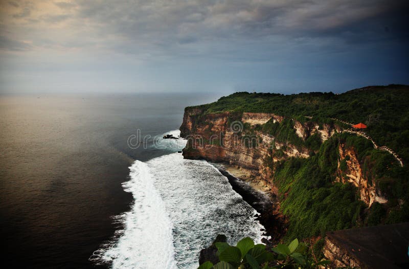 Scenic view of surf and steep cliffs on ocean coastline, Bali, Indonesia. Scenic view of surf and steep cliffs on ocean coastline, Bali, Indonesia.