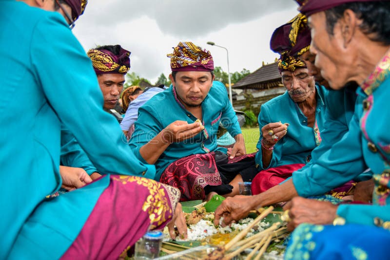 Bali kallade traditionell kultur Megibung för att äta samman med 4-6 personer på den samma plattan royaltyfri bild Bali kallade traditionell kultur Megibung för att äta samman med 4-6 personer på den samma plattan royaltyfri bild