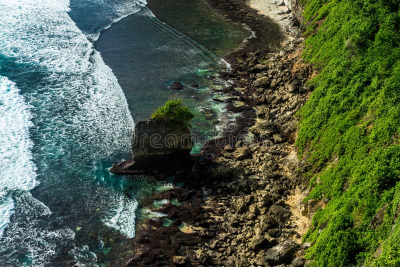 View down to the wild waters on the balinese shores, Uluwatu, Bali, Indonesia. View down to the wild waters on the balinese shores, Uluwatu, Bali, Indonesia.