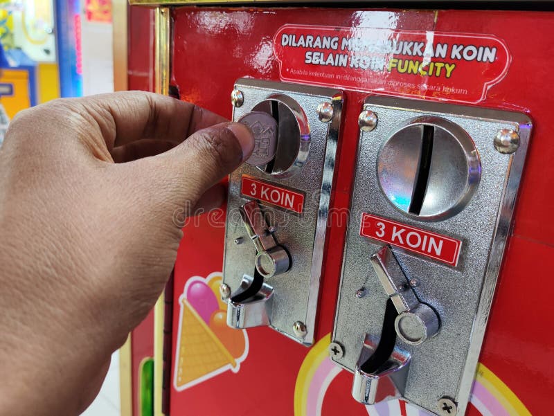 Players hands interacting and insert coin to play stock photos