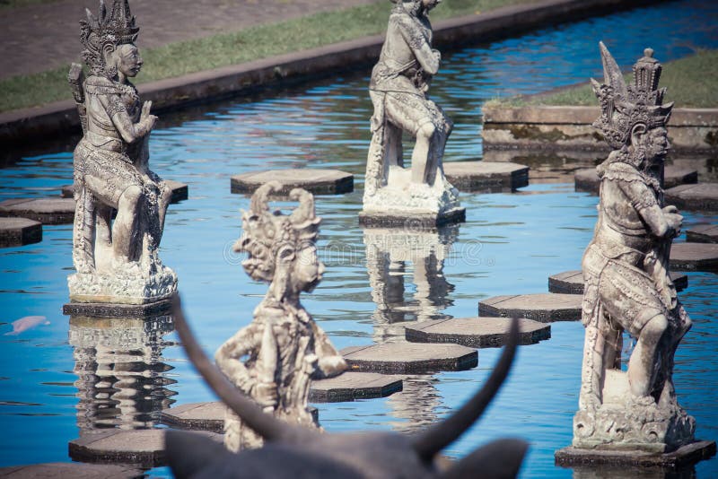 Balinese god at water background stock photos Balinese god at water background stock photos