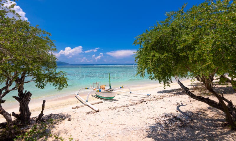 Balinese outrigger fishing boat 2. A balinese outrigger fishing boat pulled up on the beach in the gili islands,bali royalty free stock photos Balinese outrigger fishing boat 2. A balinese outrigger fishing boat pulled up on the beach in the gili islands,bali royalty free stock photos