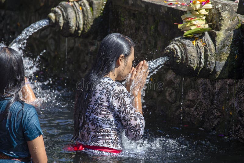 Balinesefamiljer kommer till den sakrala templet för vårvatten av Tirta Empul i Bali, Indonesien att be och rentvå deras anda arkivfoton Balinesefamiljer kommer till den sakrala templet för vårvatten av Tirta Empul i Bali, Indonesien att be och rentvå deras anda arkivfoton